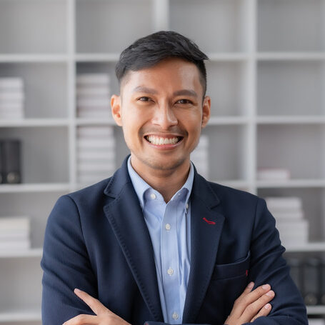 Portrait of Asian businessman in the office. Crossed arms. Confident Asian Businessman Standing in Office.